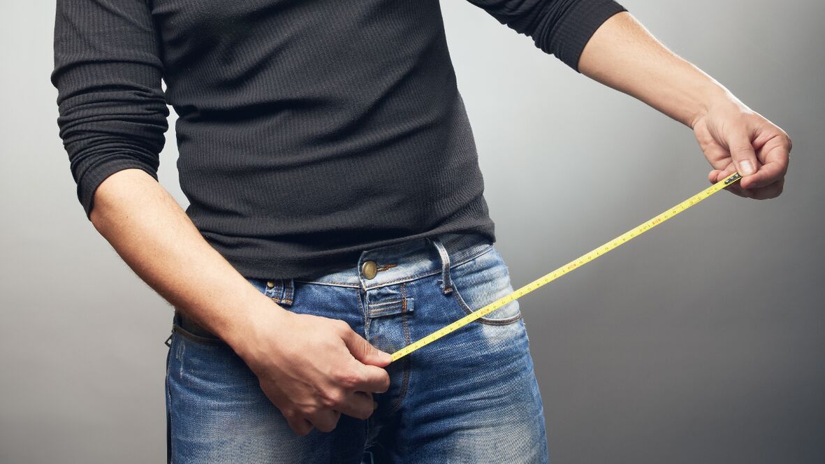 Man measuring penis after it has grown