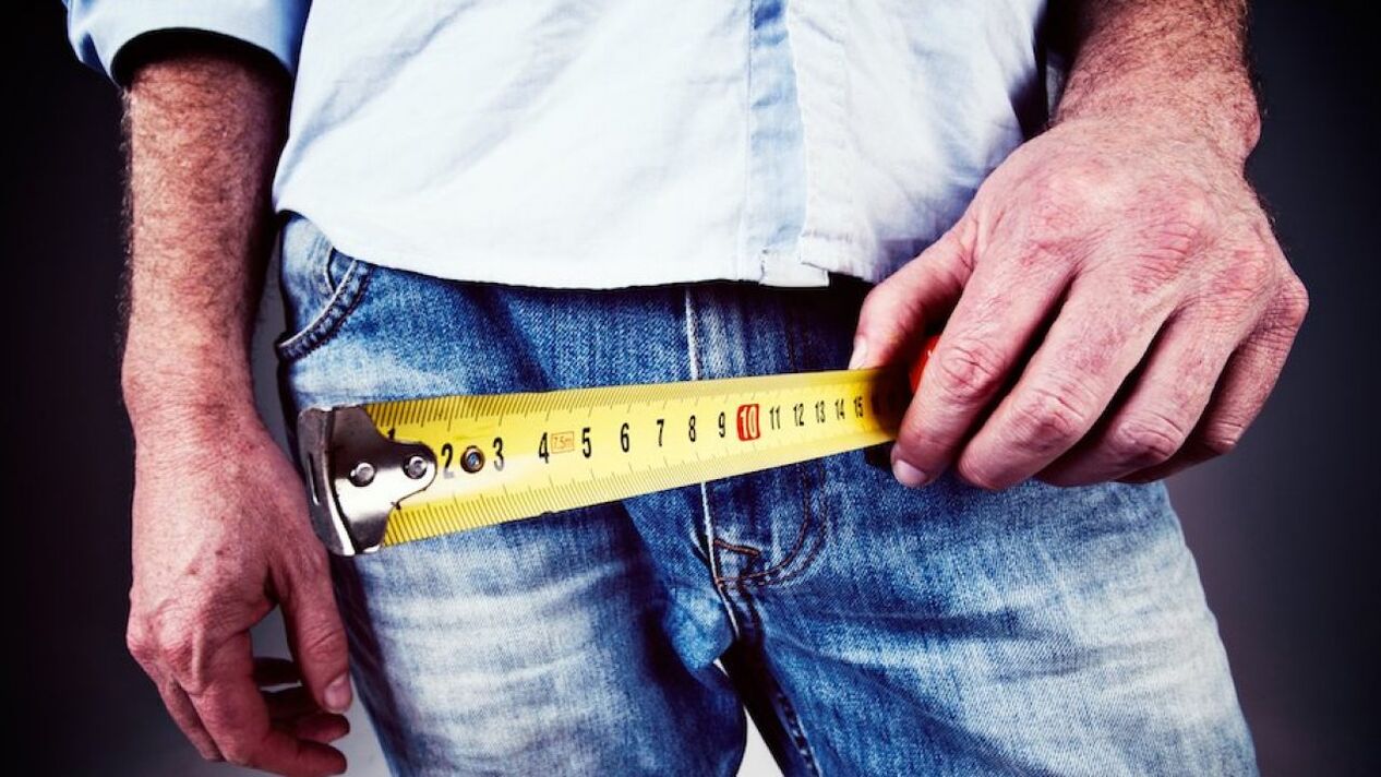 Man measuring penis before enlarging it