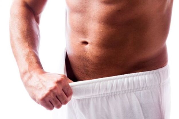 Man assessing penis size